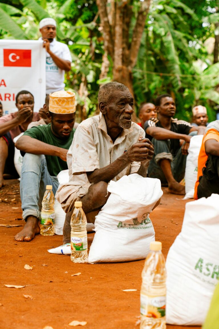 People gathered for aid distribution, featuring groceries and essentials.